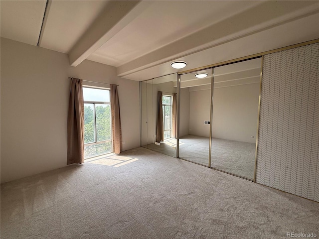 1888 S Jackson St Unit 603, Denver, CO 80210 - unfurnished bedroom featuring carpet floors, beam ceiling, and a closet