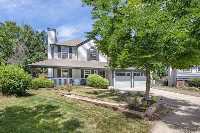 13275 W 63rd Pl, Arvada, CO 80004 - view of front facade featuring a porch, concrete driveway, a chimney, a front lawn, and roof with shingles