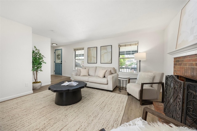 13275 W 63rd Pl, Arvada, CO 80004 - living room featuring wood finished floors and a brick fireplace