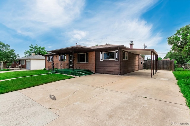 3334 W Grand Ave, Englewood, CO 80110 - single story home featuring driveway, a carport, and a chimney