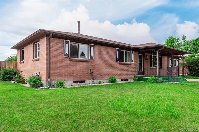 3334 W Grand Ave, Englewood, CO 80110 - view of front of property with brick siding, a front lawn, and a porch