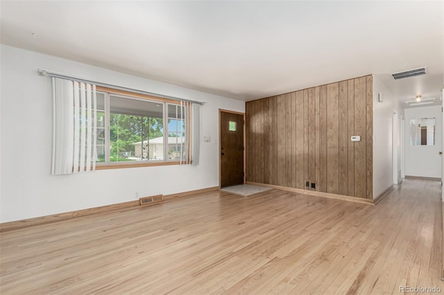 3334 W Grand Ave, Englewood, CO 80110 - unfurnished living room with wood finished floors and wooden walls