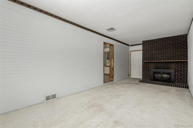 3334 W Grand Ave, Englewood, CO 80110 - unfurnished living room with brick wall, carpet, and a brick fireplace