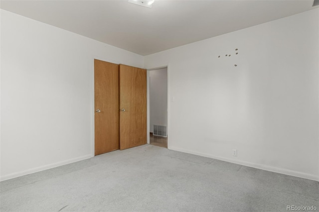 3334 W Grand Ave, Englewood, CO 80110 - unfurnished bedroom featuring light colored carpet and baseboards