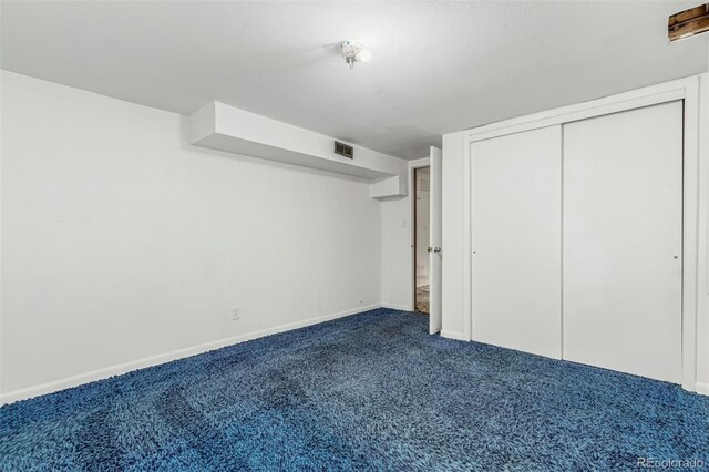 3334 W Grand Ave, Englewood, CO 80110 - unfurnished bedroom featuring dark carpet and a closet
