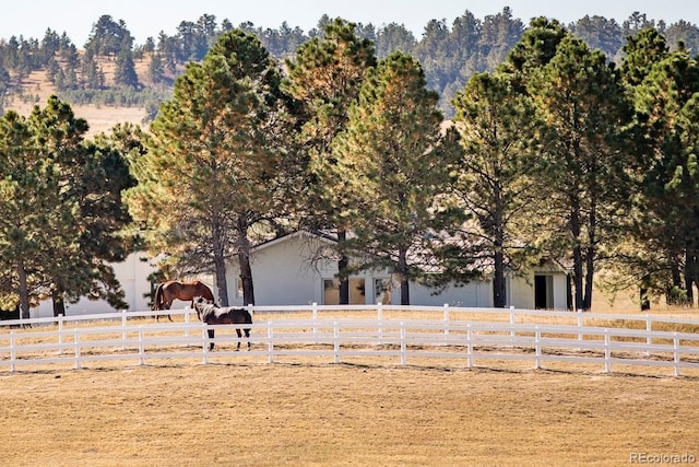 exterior space with a rural view and a garage