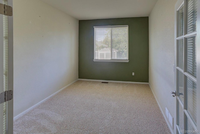 spare room with carpet flooring and baseboards