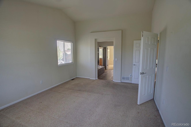 unfurnished bedroom featuring lofted ceiling, carpet flooring, and baseboards