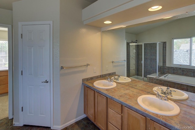 full bathroom featuring a stall shower, double vanity, a garden tub, baseboards, and recessed lighting
