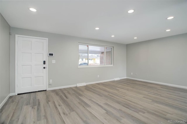 foyer entrance with light hardwood / wood-style floors