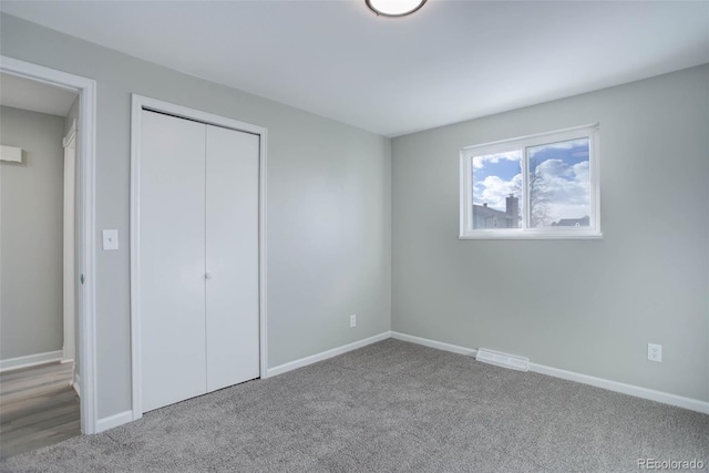 unfurnished bedroom with carpet and a closet