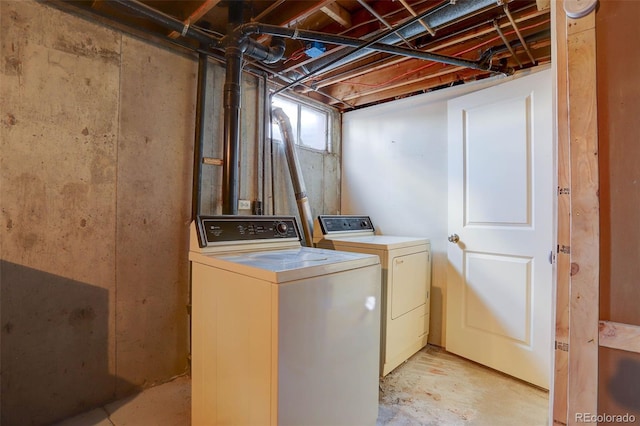 clothes washing area featuring independent washer and dryer