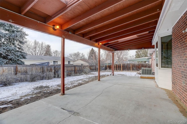 snow covered patio featuring central AC