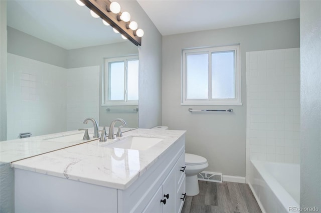 bathroom with vanity, hardwood / wood-style floors, and toilet