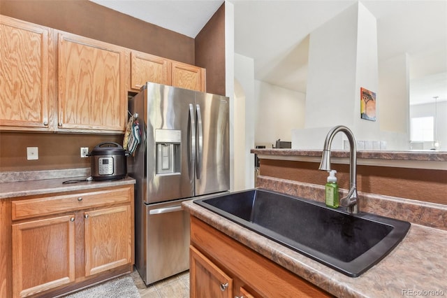 kitchen with stainless steel fridge and sink