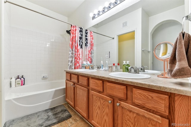 bathroom with shower / bath combination with curtain, vanity, and tile patterned flooring