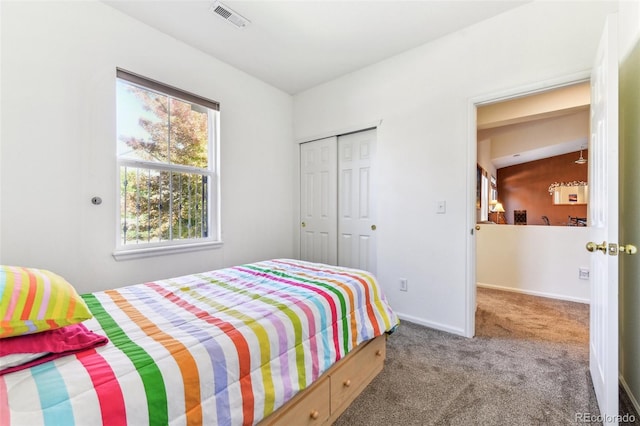 bedroom featuring vaulted ceiling, a closet, and carpet flooring