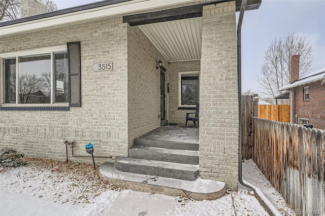 view of snow covered property entrance