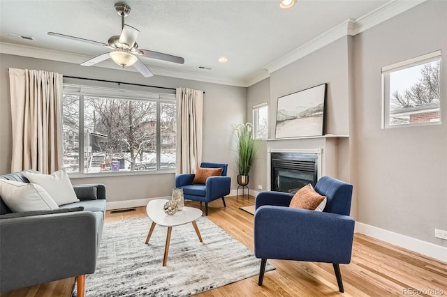 sitting room featuring crown molding, ceiling fan, and light hardwood / wood-style floors