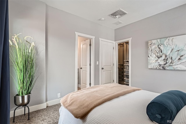 carpeted bedroom featuring a spacious closet