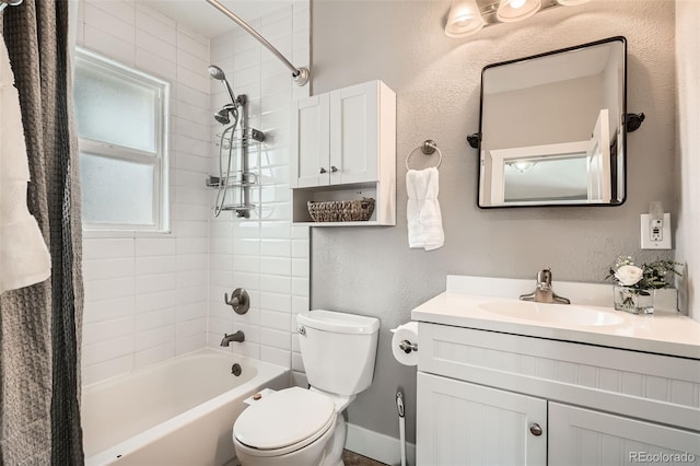 full bathroom featuring tiled shower / bath combo, vanity, and toilet