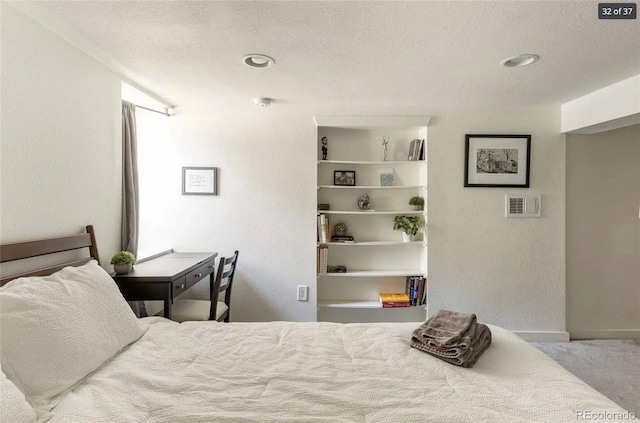 carpeted bedroom featuring a textured ceiling