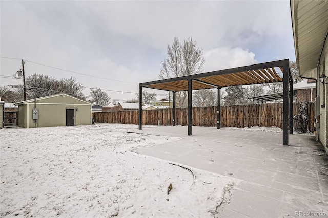 yard covered in snow featuring an outbuilding