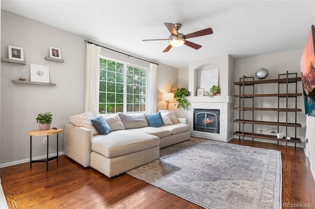 14794 Vine St, Thornton, CO 80602 - living room with a ceiling fan, a stone fireplace, wood finished floors, and baseboards