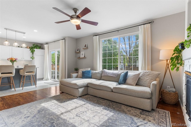 14794 Vine St, Thornton, CO 80602 - living room featuring wood finished floors, a ceiling fan, and healthy amount of natural light