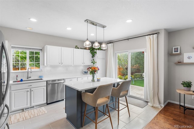 14794 Vine St, Thornton, CO 80602 - kitchen with stainless steel appliances, a sink, backsplash, white cabinets, and recessed lighting