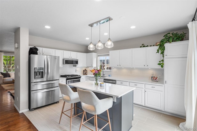 14794 Vine St, Thornton, CO 80602 - kitchen featuring stainless steel appliances, plenty of natural light, white cabinets, tasteful backsplash, and recessed lighting