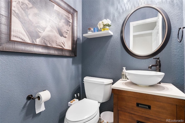 14794 Vine St, Thornton, CO 80602 - half bathroom featuring a textured wall, toilet, and vanity