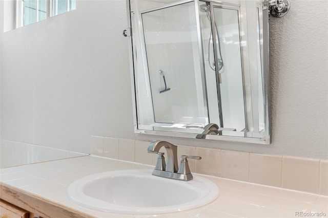 14794 Vine St, Thornton, CO 80602 - bathroom with a stall shower, a textured wall, and vanity