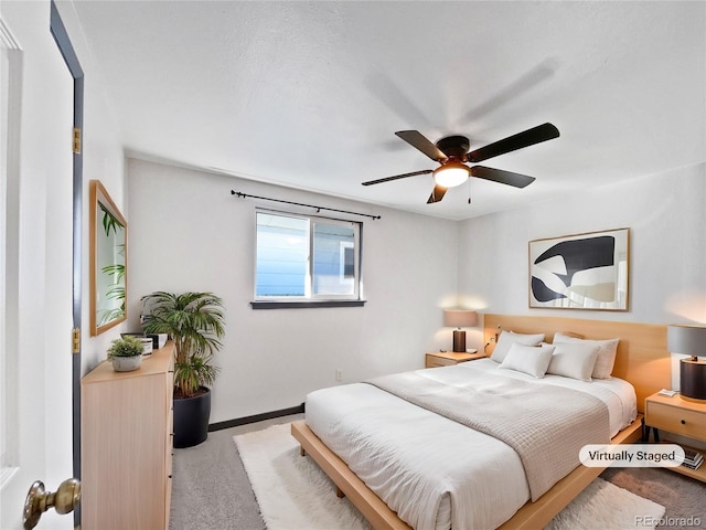 bedroom featuring ceiling fan and light colored carpet