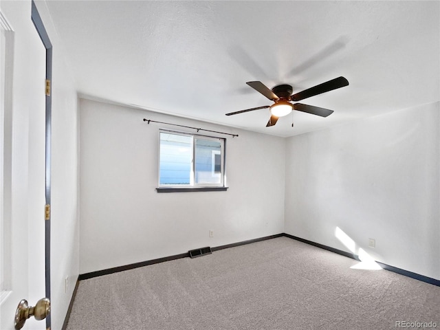 empty room featuring ceiling fan and carpet floors