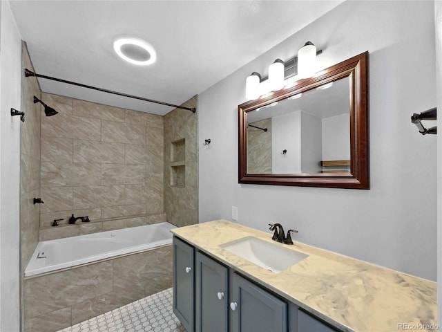 bathroom with tiled shower / bath combo, vanity, and tile patterned floors