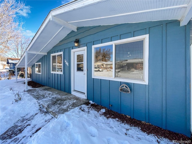 view of snow covered property entrance