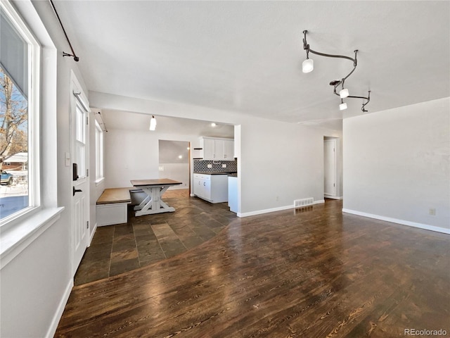 unfurnished living room featuring dark hardwood / wood-style flooring