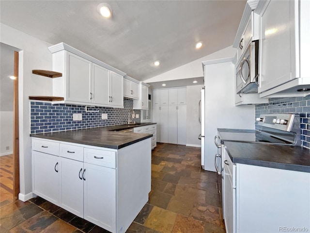 kitchen with lofted ceiling, sink, stainless steel appliances, and white cabinets