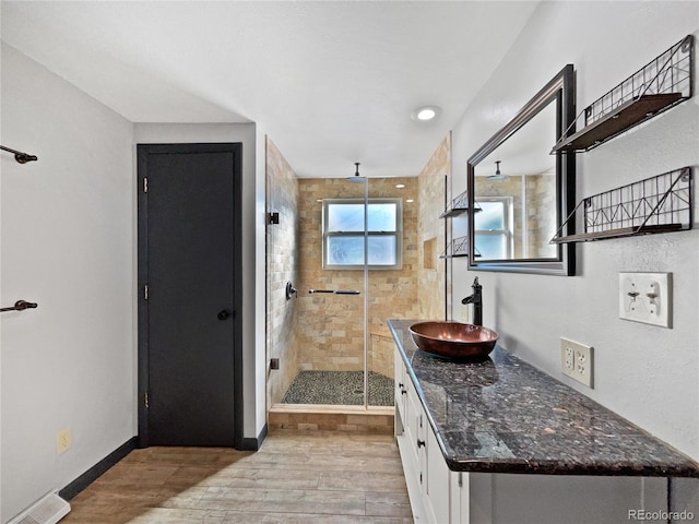 bathroom featuring vanity and an enclosed shower