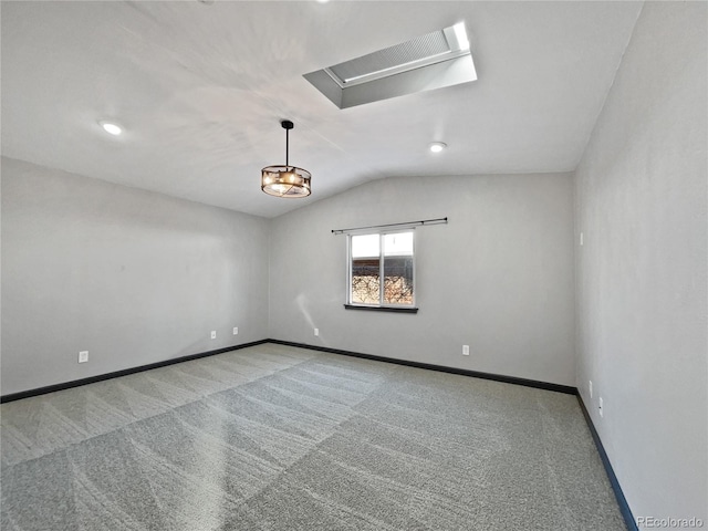 empty room with vaulted ceiling and light colored carpet