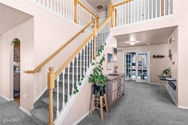 25 Tierra Casa Dr, Pueblo, CO 81005 - staircase featuring carpet floors and a high ceiling