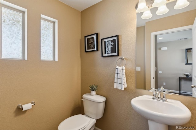 bathroom featuring visible vents, a sink, and toilet