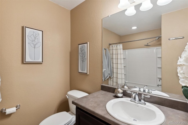 bathroom with a shower with curtain, a textured wall, vanity, and toilet