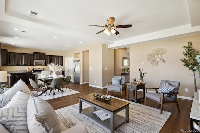 living area with recessed lighting, wood finished floors, visible vents, baseboards, and ceiling fan