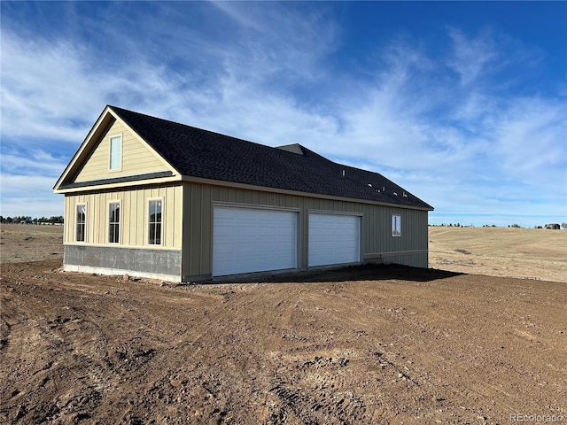 view of side of home featuring an outdoor structure and a garage