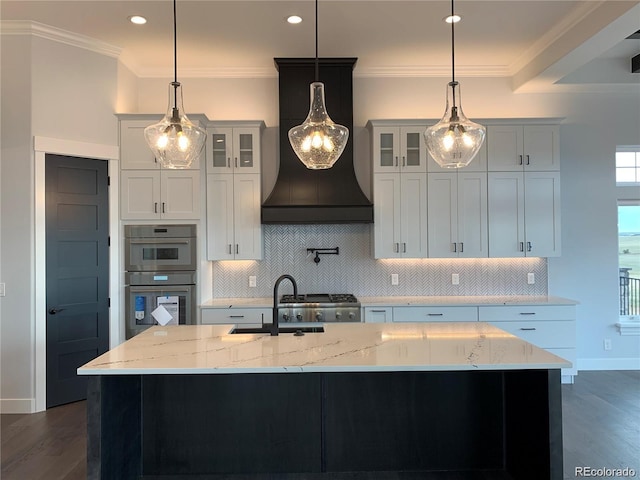 kitchen with white cabinets, decorative light fixtures, and a spacious island