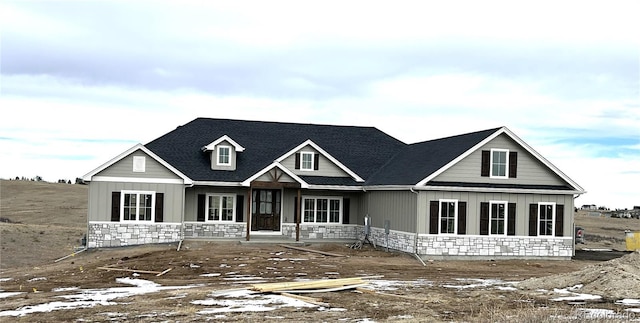 view of front of house featuring stone siding and board and batten siding