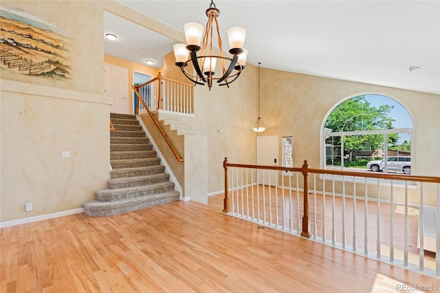 6846 Edgewood Way, Highlands Ranch, CO 80130 - stairway featuring wood finished floors and a chandelier