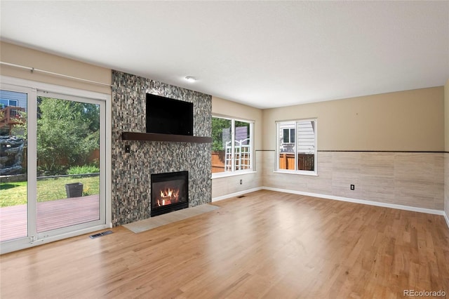 6846 Edgewood Way, Highlands Ranch, CO 80130 - unfurnished living room with wood finished floors and a large fireplace